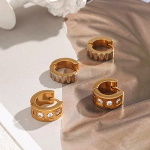 Detailed macro view of 18K gold plated square zircon and wavy textured hoop earrings