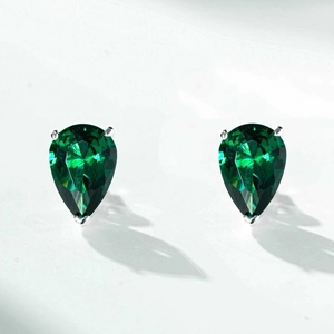 Close-up of S925 sterling silver stud earrings featuring green pear cut stones in 3-prong setting
