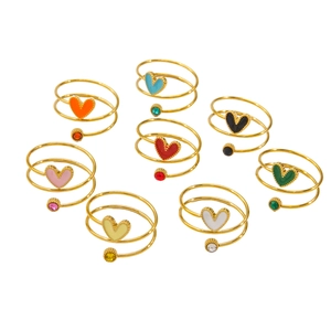 Set of eight colorful enamel heart spiral rings in gold finish with small zircon accents