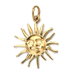 Macro shot of sun face pendant in gold finish with radiant beams on a white background