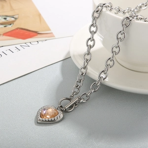 Detail of a champagne heart crystal pendant with silver toggle clasp and thick chain