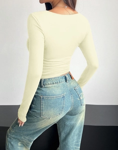 Back view of beige slim-fit square neck long sleeve top with textured fabric detail