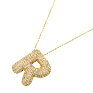 Macro shot of 18K gold plated letter R bubble pendant necklace with CZ stones