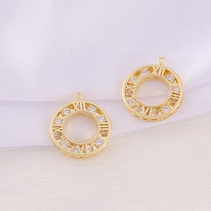 Close-up of a gold-plated circular pendant with cubic zirconia and Roman numerals
