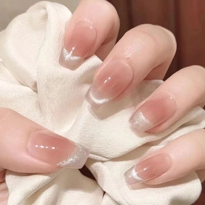 Short coffin press-on nails with nude pink to glittery silver gradient finish