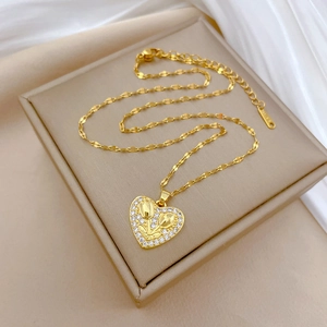 Luxury heart tulip necklace in gold finish with sparkling zircon halo on silk background