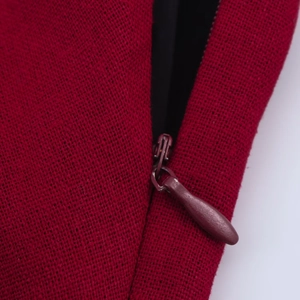 Detailed close-up of a hidden zipper on a red linen asymmetrical dress for women