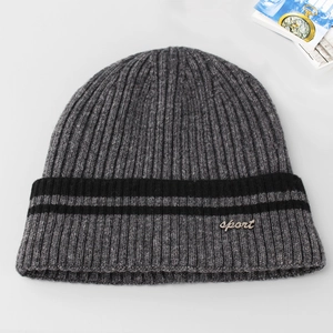 Close-up of grey knitted beanie with sport metal tag and black double stripe detail