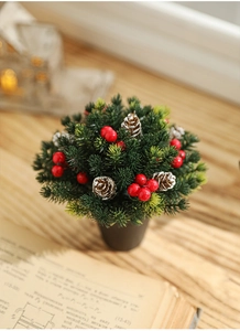 Detail of 13cm mini Christmas tree with snow pine cones and red berries in black pot