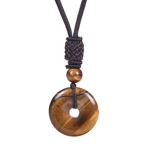 Detail view of round tiger eye stone pendant with dark brown braided rope cord