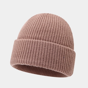Detail showing the fine rib-knit texture and cuffed hem of the tan winter beanie cap