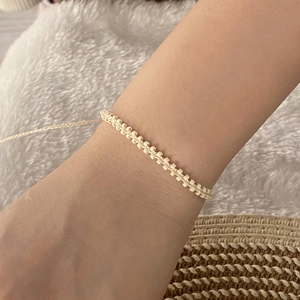 Close-up of bohemian beaded bracelet worn on wrist with casual natural background
