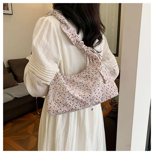 Floral tote bag shoulder view showing ruffled strap and fresh summer print on white fabric