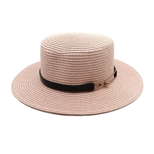 Close-up of fine woven straw boater hat with black leather band and gold buckle detail