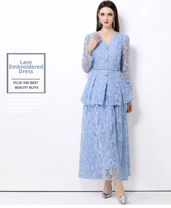 Detail view of light blue lace embroidery fabric and delicate floral texture on dress