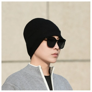 Close-up of a black ribbed knit beanie with thermal fleece lining for outdoor winter warmth