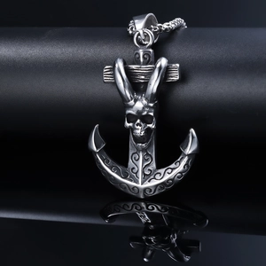Silver stainless steel anchor necklace with skull detail on a reflective black background