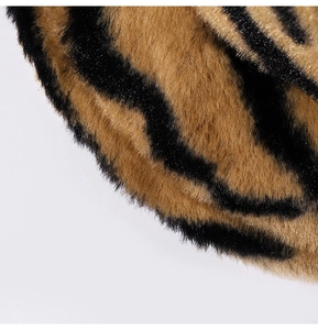 Detailed texture of zebra print faux fur bucket hat with thick brown and black patterns