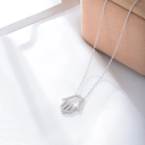 Macro detail of S925 sterling silver Hamsa Hand pendant necklace with zircon stones