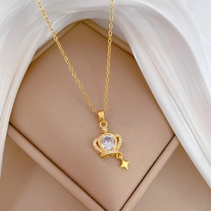 Elegant gold crown necklace with sparkling crystals and star pendant on silk