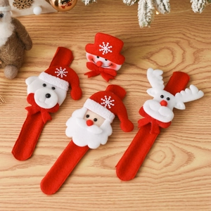 Christmas slap bracelets with Santa, snowman, and reindeer figures on wooden background