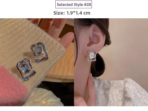Detail view of silver tassel earrings with crystal inlay and 1.9x1.4cm dimensions