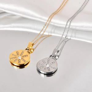 Detail of gold and silver sunburst necklaces with rhinestones on silk fabric