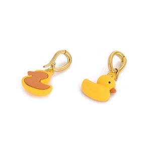 Detailed close-up of cute 3D yellow duck pendants with gold lobster clasps and smooth finish