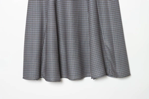 Detailed close-up showing the houndstooth pattern texture and fabric of the midi skirt