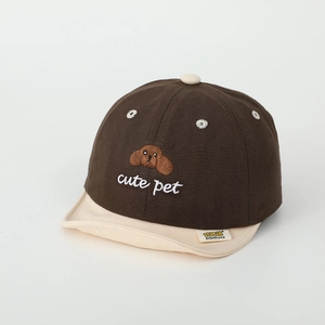 Close-up of cute dog embroidery and cotton texture on brown infant baseball cap