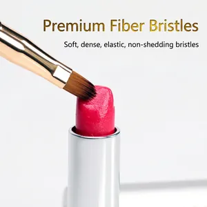 Dual-ended retractable lip brush with soft synthetic bristles and gold ferrule detail