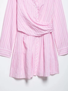 Detailed view of pink and white striped V-neck dress with wrap waist and front buttons
