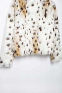Detailed macro view showing the soft white and brown faux leopard fur texture and fibers