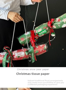 Detailed view of Christmas candy bouquet wrapping paper with festive patterns and pearls