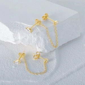 Detailed view of S925 sterling silver gold stud earring with chain tassel on stone blocks