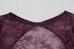Close-up of deep purple lace dress neckline showing intricate floral mesh and piping