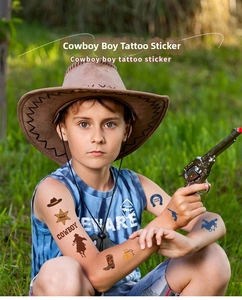 Boy wearing western cowboy temporary tattoos featuring sheriff stars and hats