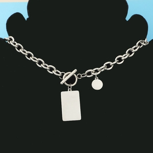 Detail of silver stainless steel thick chain necklace with OT buckle and blank pendants