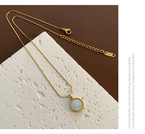 Detail of adjustable 18K gold plated steel chain and natural white shell pendant