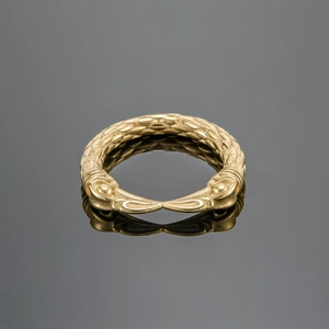 Men's retro gold punk eagle beak ring with vintage embossed textures on a gray surface