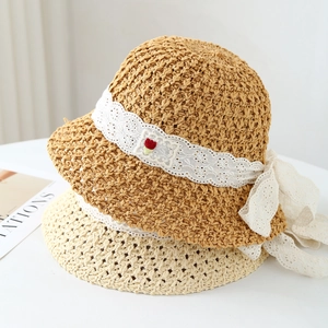 Women's woven straw sun hat with white lace ribbon and floral patch detail