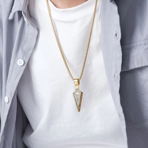Gold arrowhead pendant necklace with box chain for men worn over a white T-shirt