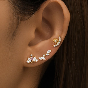 Detailed view of gold S925 sterling silver butterfly and crescent ear studs with pink zircon