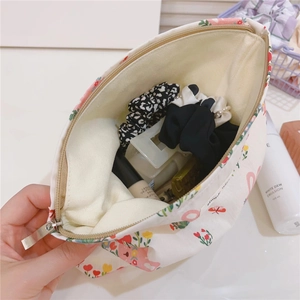 Detailed interior of a cute floral cotton makeup bag with teddy bear pattern