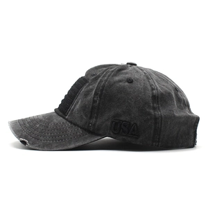 Detail of USA 3D embroidery and distressed ripped edges on a washed cotton baseball cap
