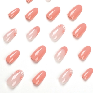 French peach pink press-on nails set with delicate white daisy flower patterns