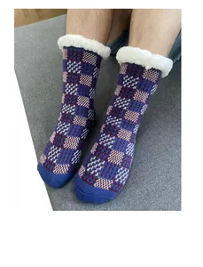 Detail of warm cable knit floor socks with thick white sherpa lining and geometric pattern