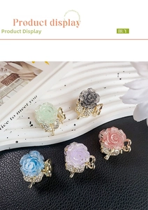 Detail of flower hair claws with glitter resin petals and rhinestone leaves decoration