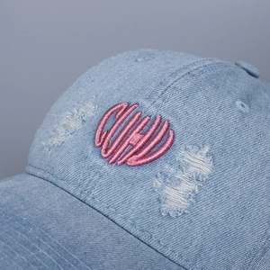 Distressed light blue denim baseball cap with pink heart letter embroidery and ripped details