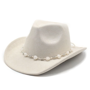 Detailed macro view of beige suede cowboy hat crown with heart bead decorative band